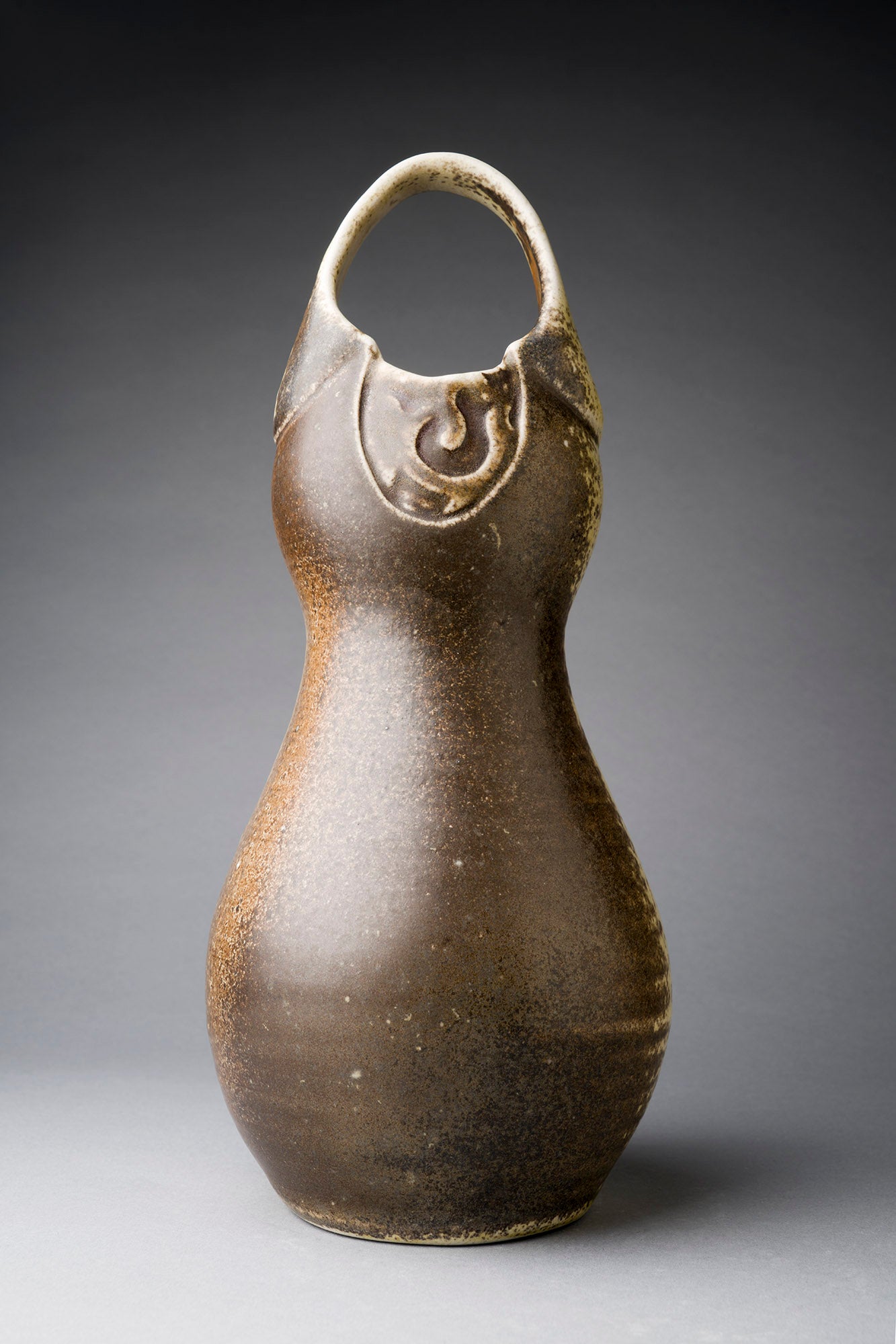 Brown clay vase with handle