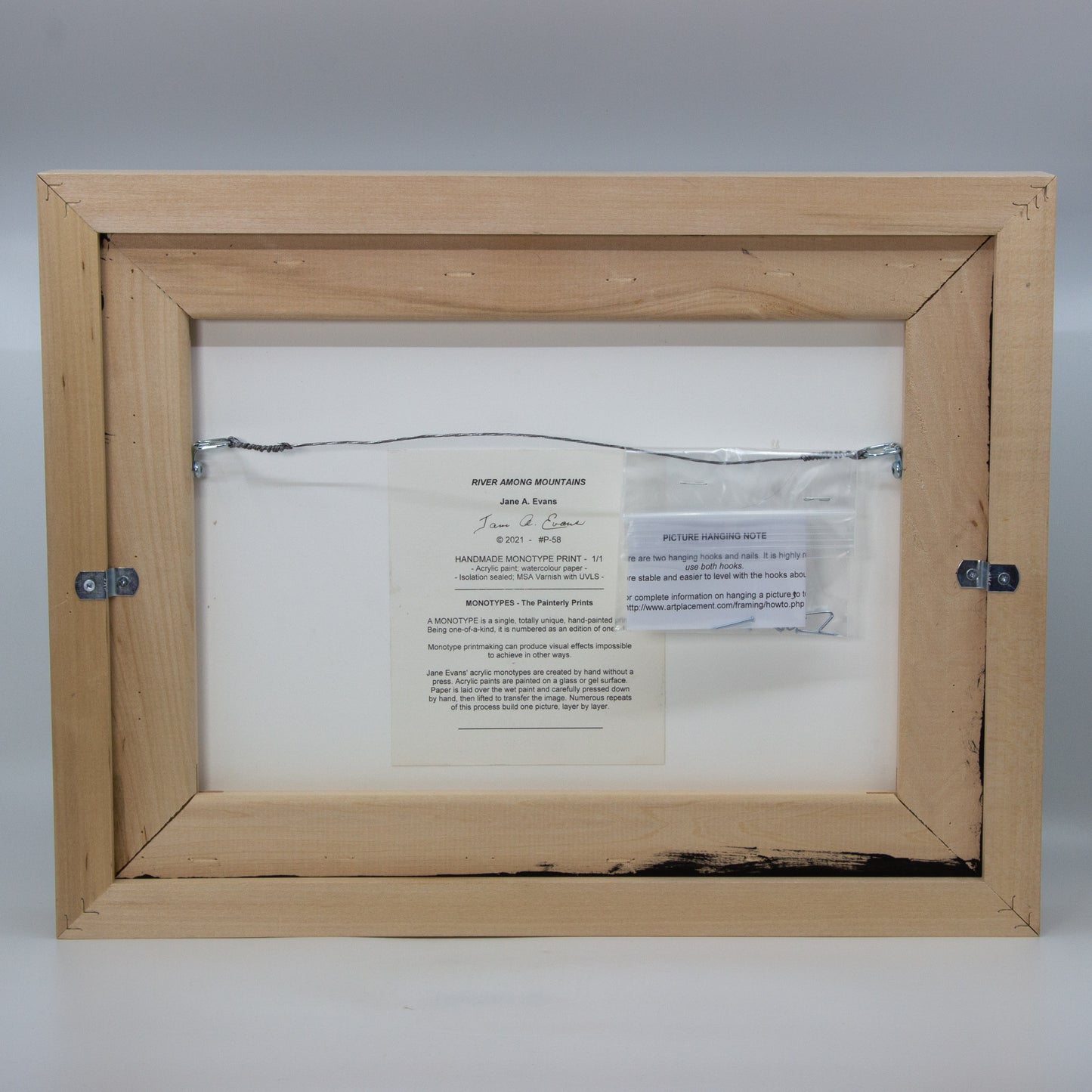 Back of framed River Among Mountains