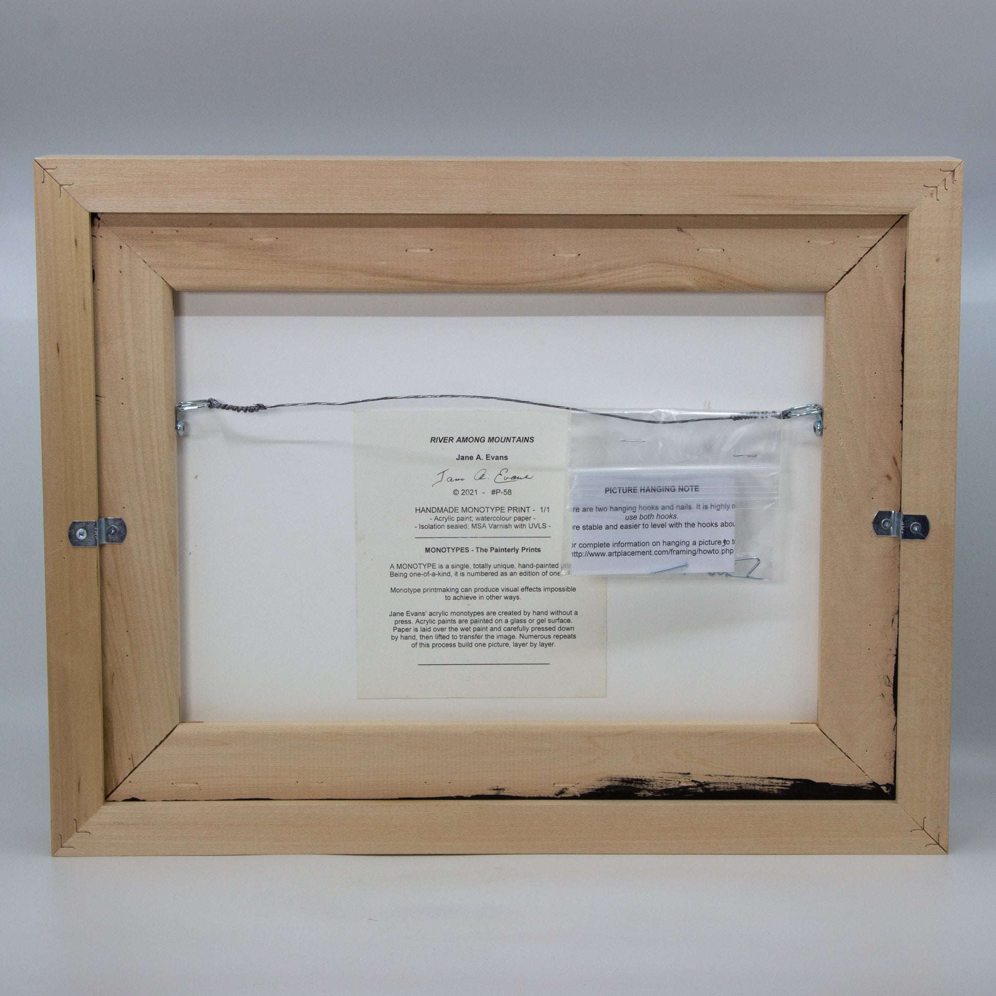 Back of framed River Among Mountains