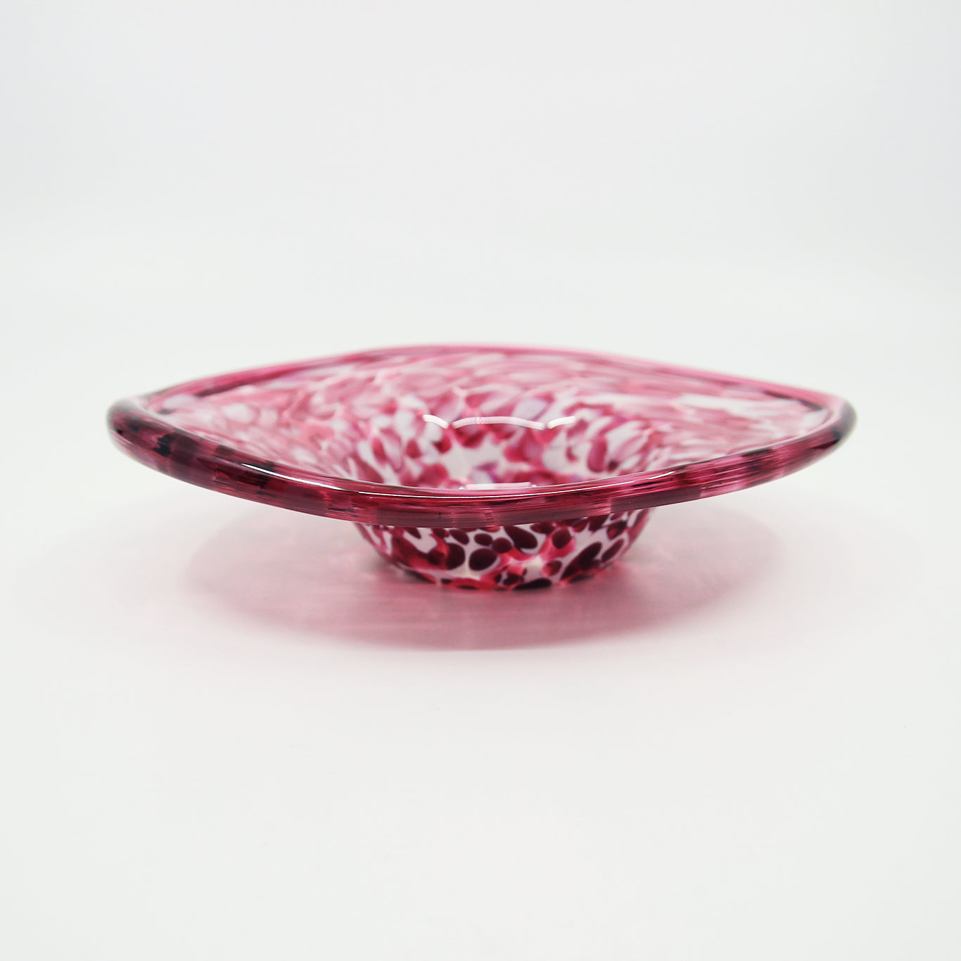 Pink, magenta, and white glass bowl with wide rim