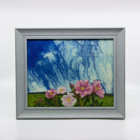 Embroidered scene of pink wild roses and sky