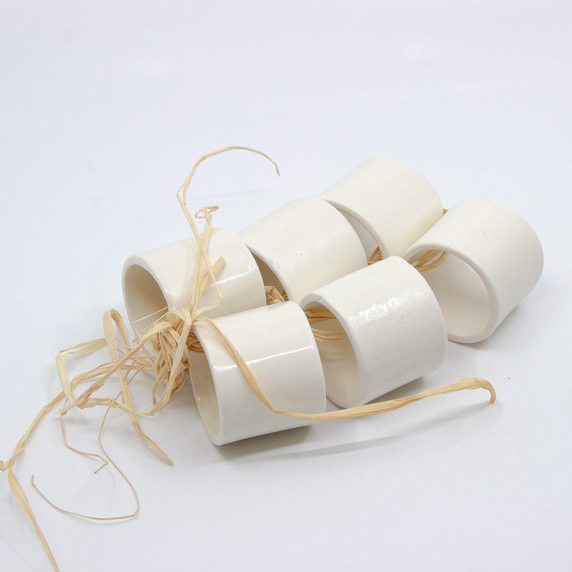 Six white clay napkin rings