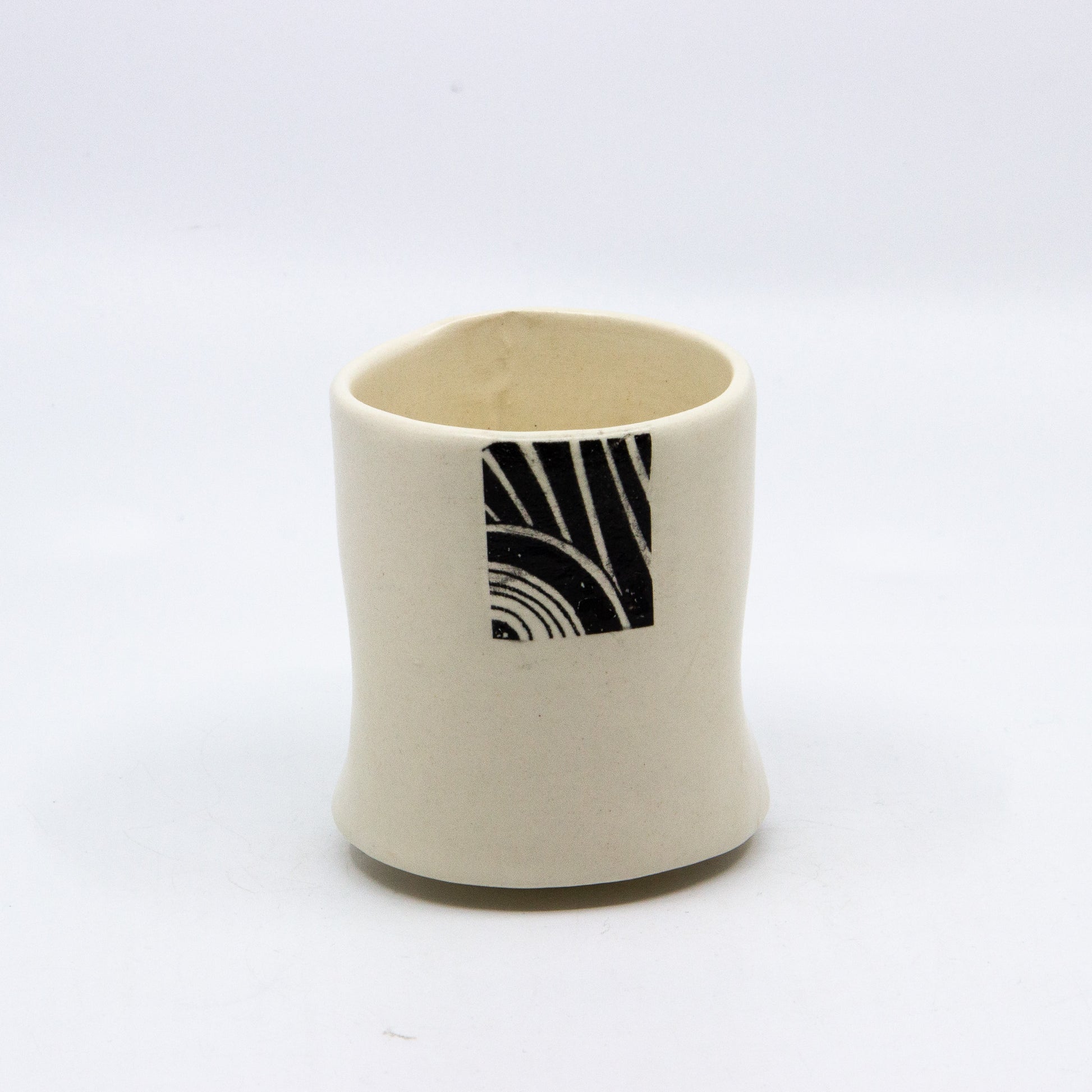 White tea cup with square pattern