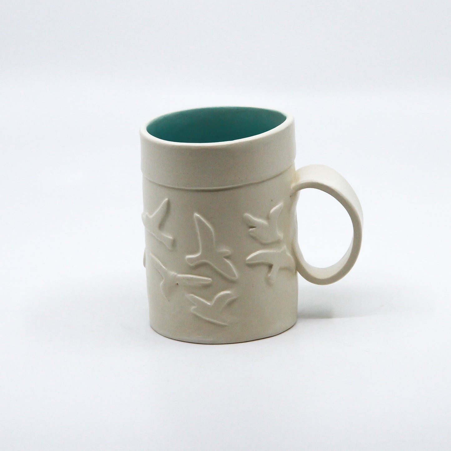 White mug with birds and turquoise inside