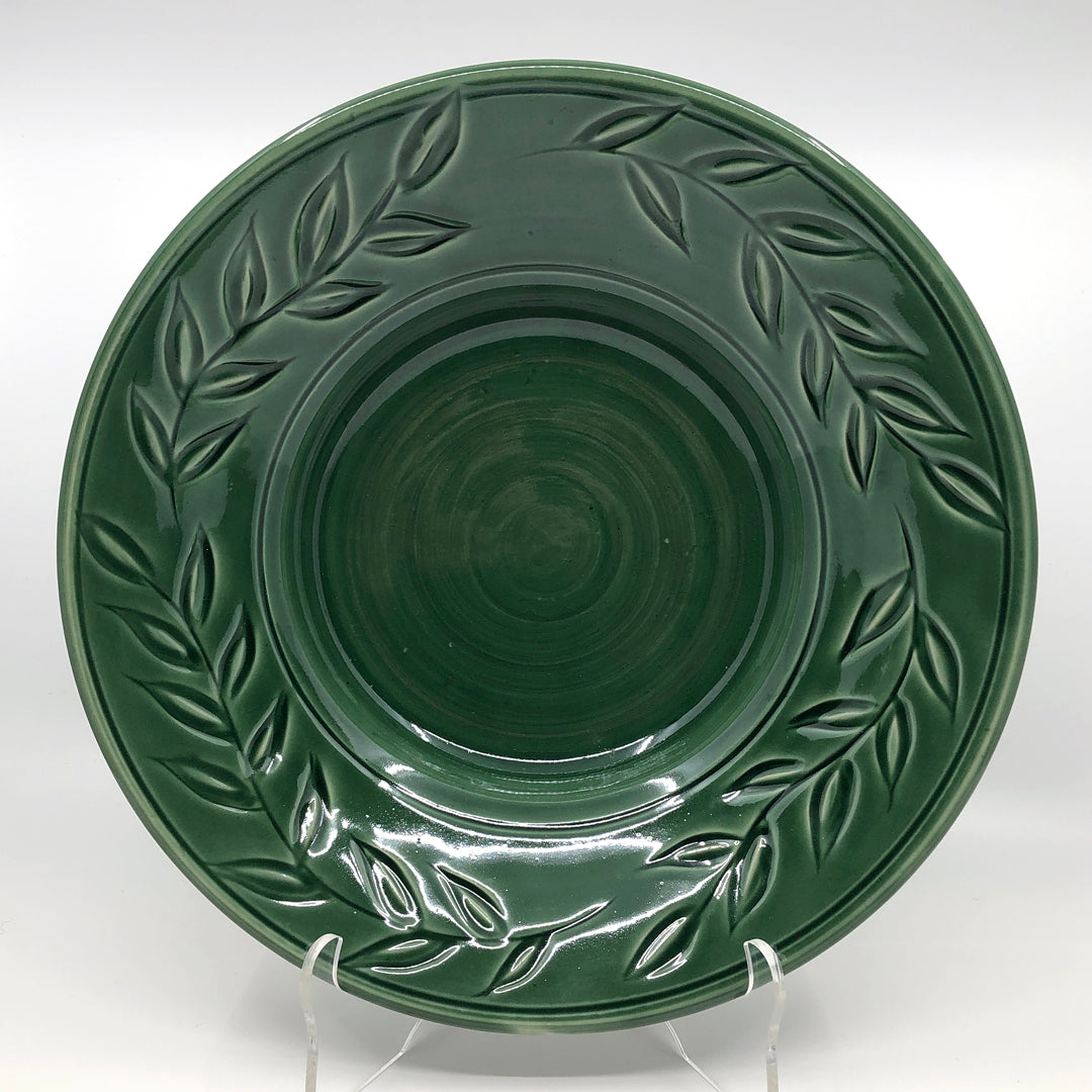 Green bowl with carved leaves on rim