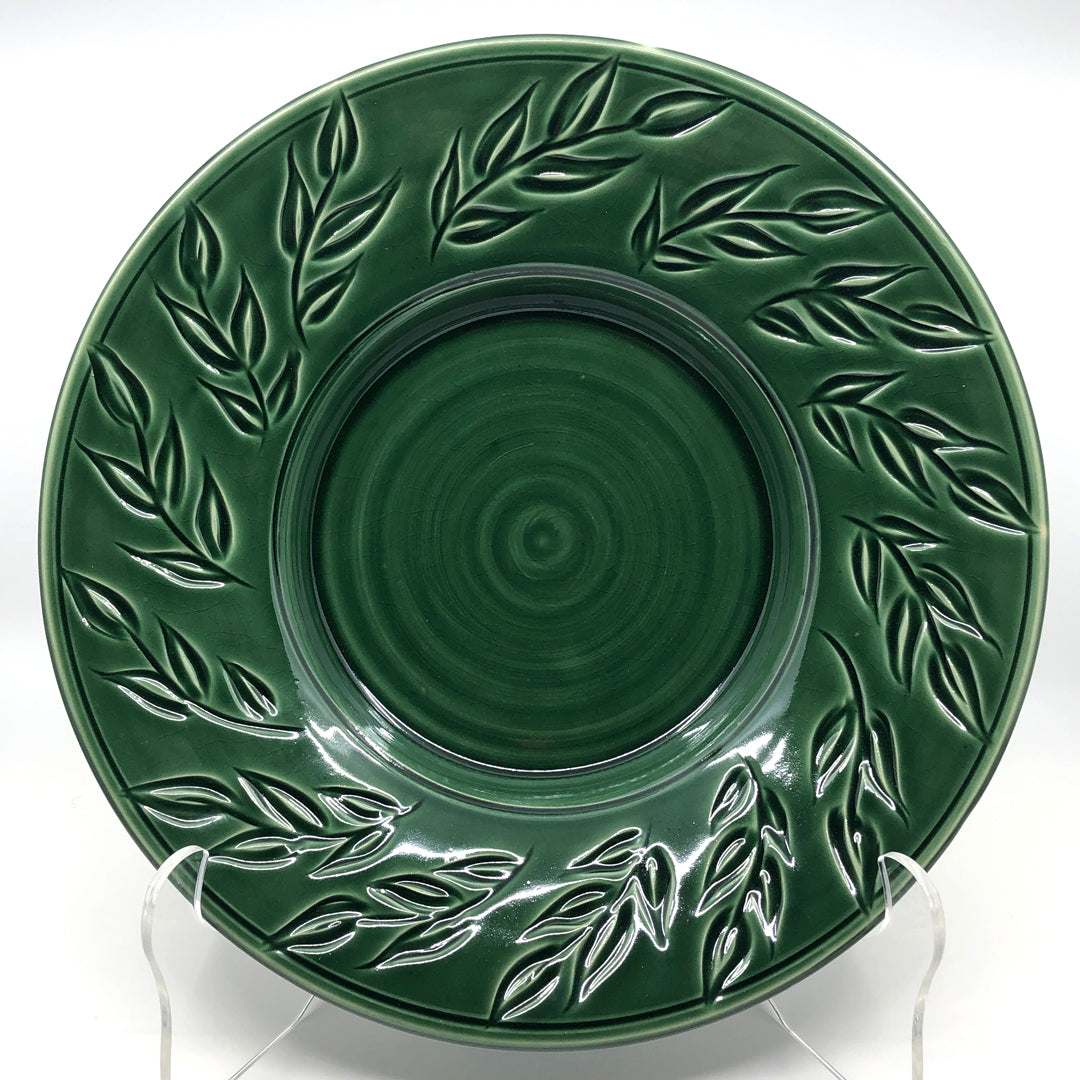 Dark green bowl with carved leaf pattern on rim