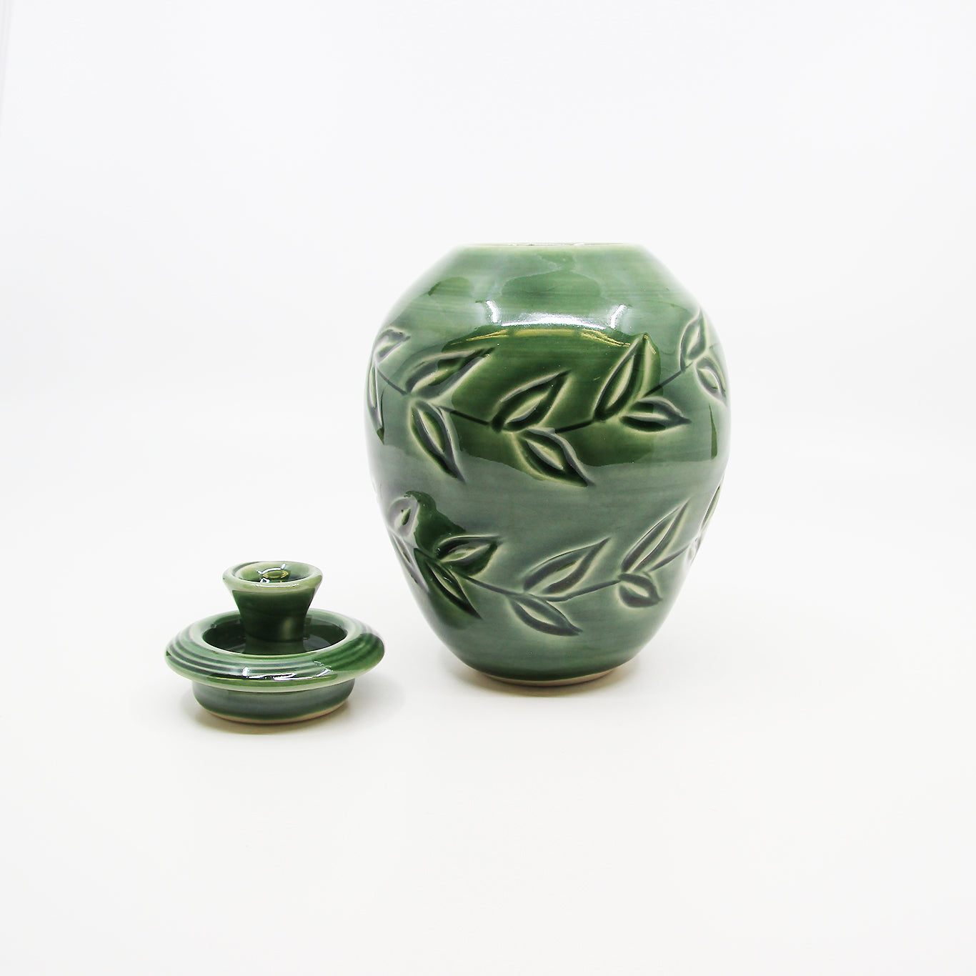 Green jar with carved leaves and lid