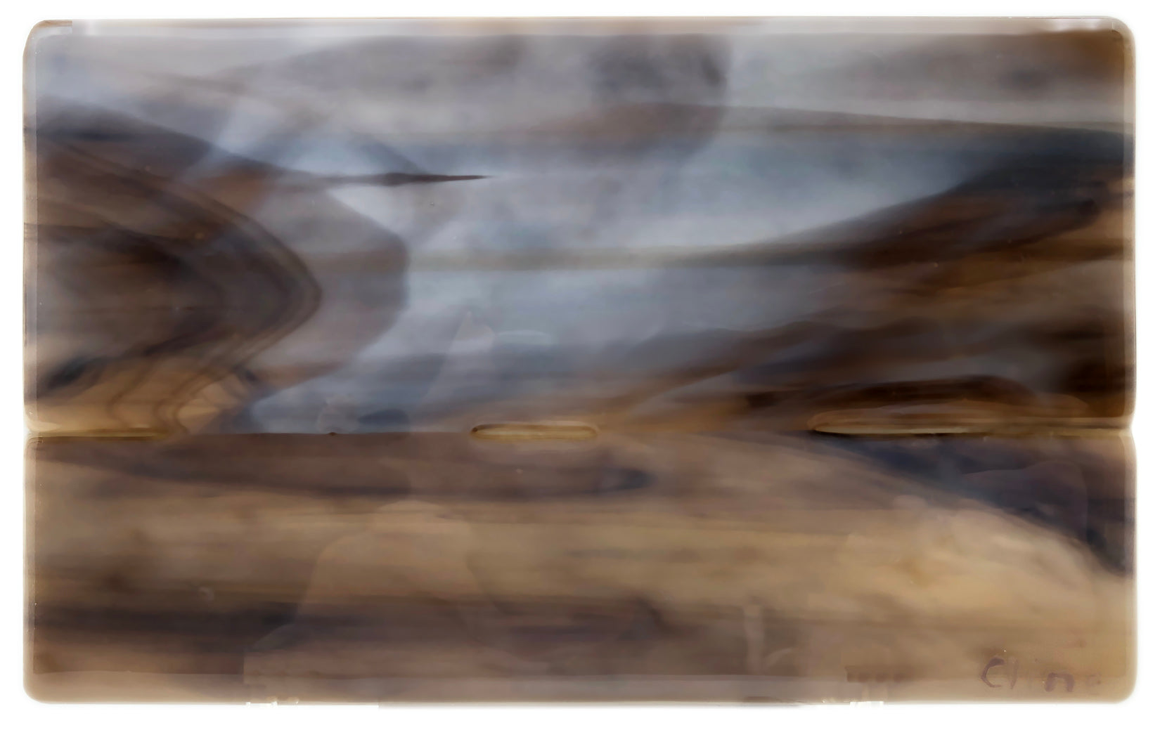 Glass tablet of grey skies and fields