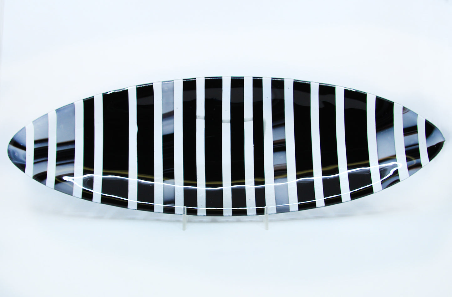 Black, white, and clear striped oval plate