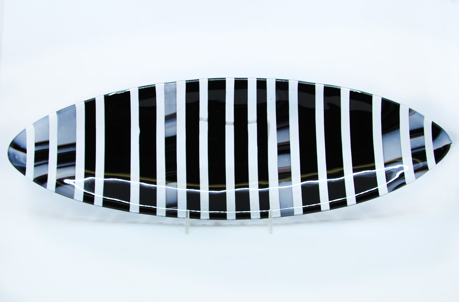 Black, white, and clear striped oval plate
