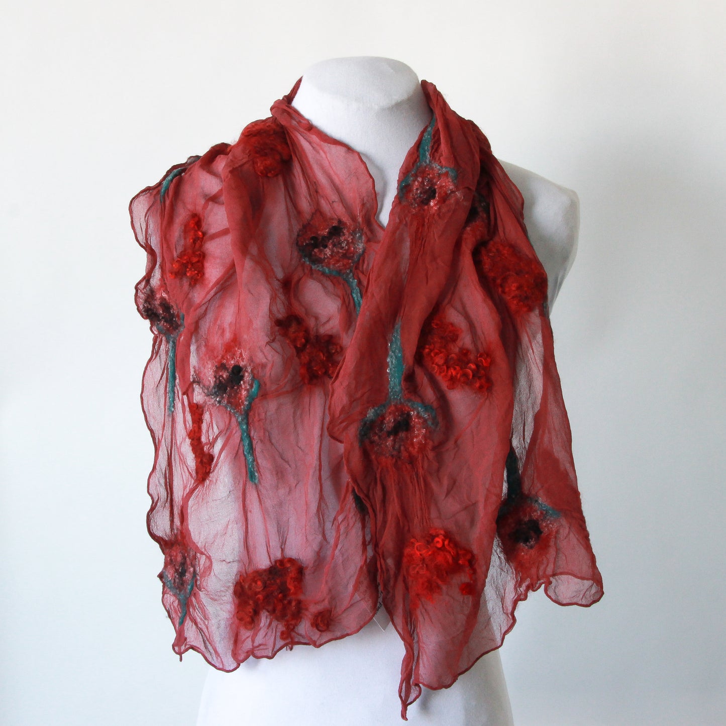 Red scarf with red and green felted sections