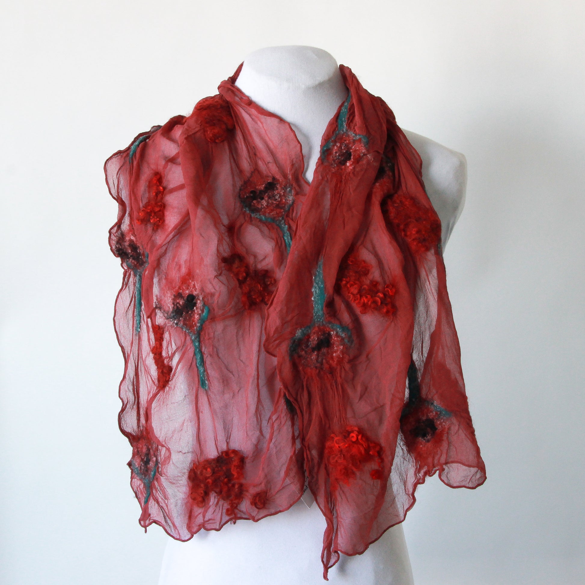 Red scarf with red and green felted sections