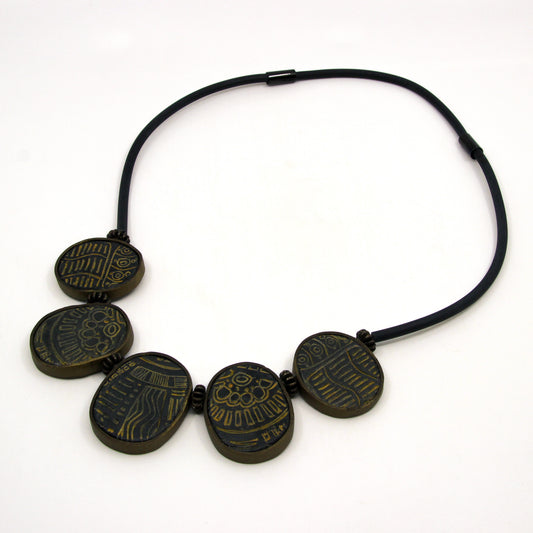 Patterned tokens on a leather strap 