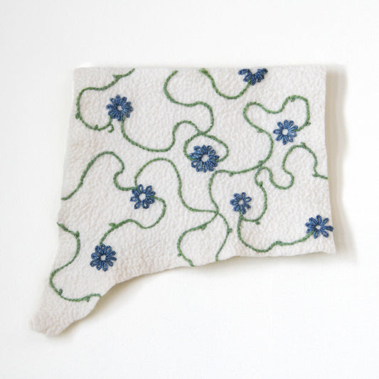 Felted wall hanging embroidered with blue flowers and green vines