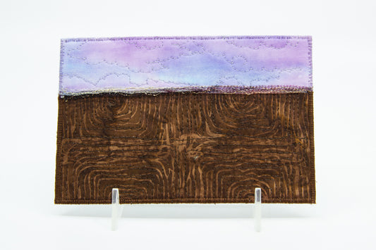 Mini art quilt of a prairie: lilac sky and brown fields