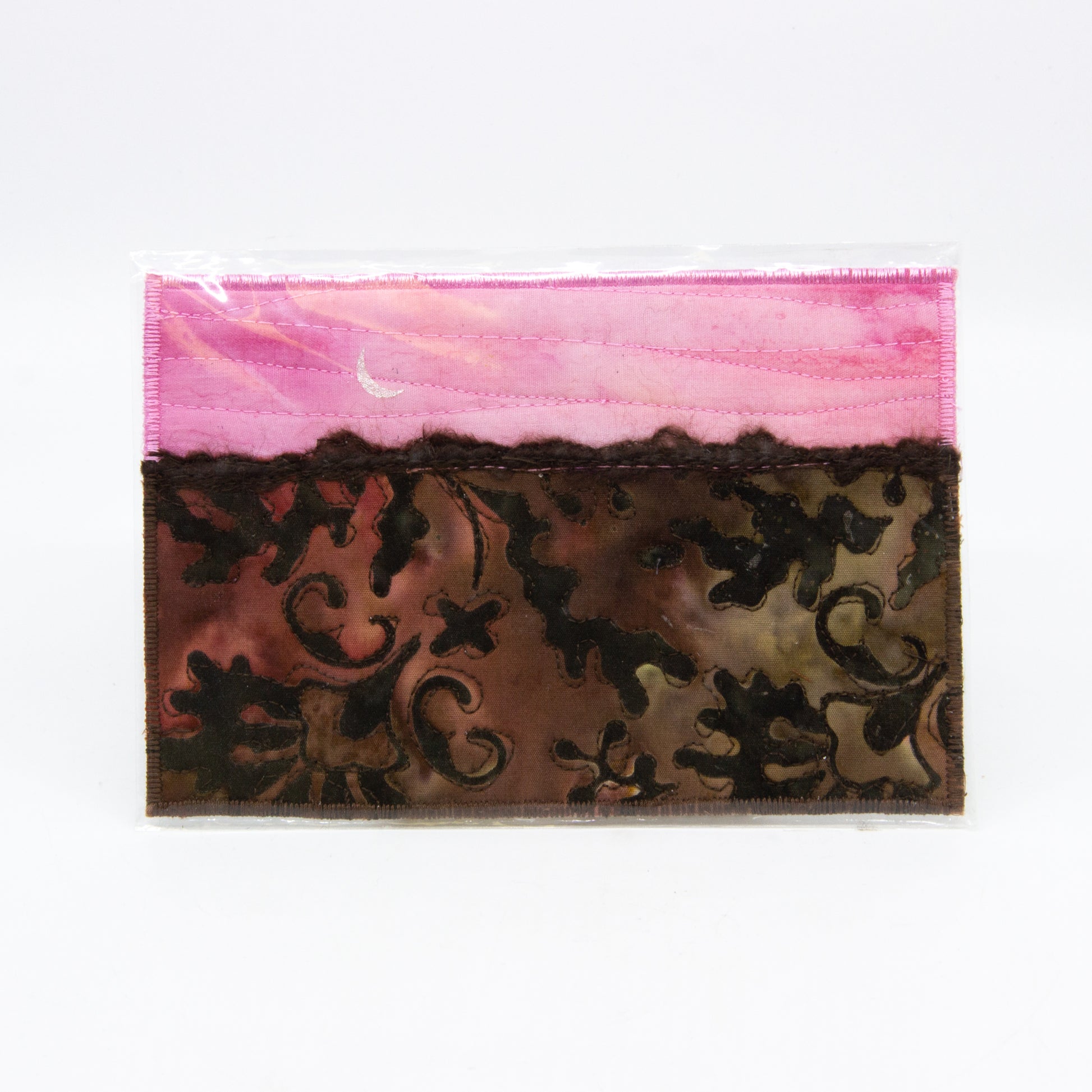 Mini art quilt of a prairie: Pink sky with moon, brown field with paisley pattern