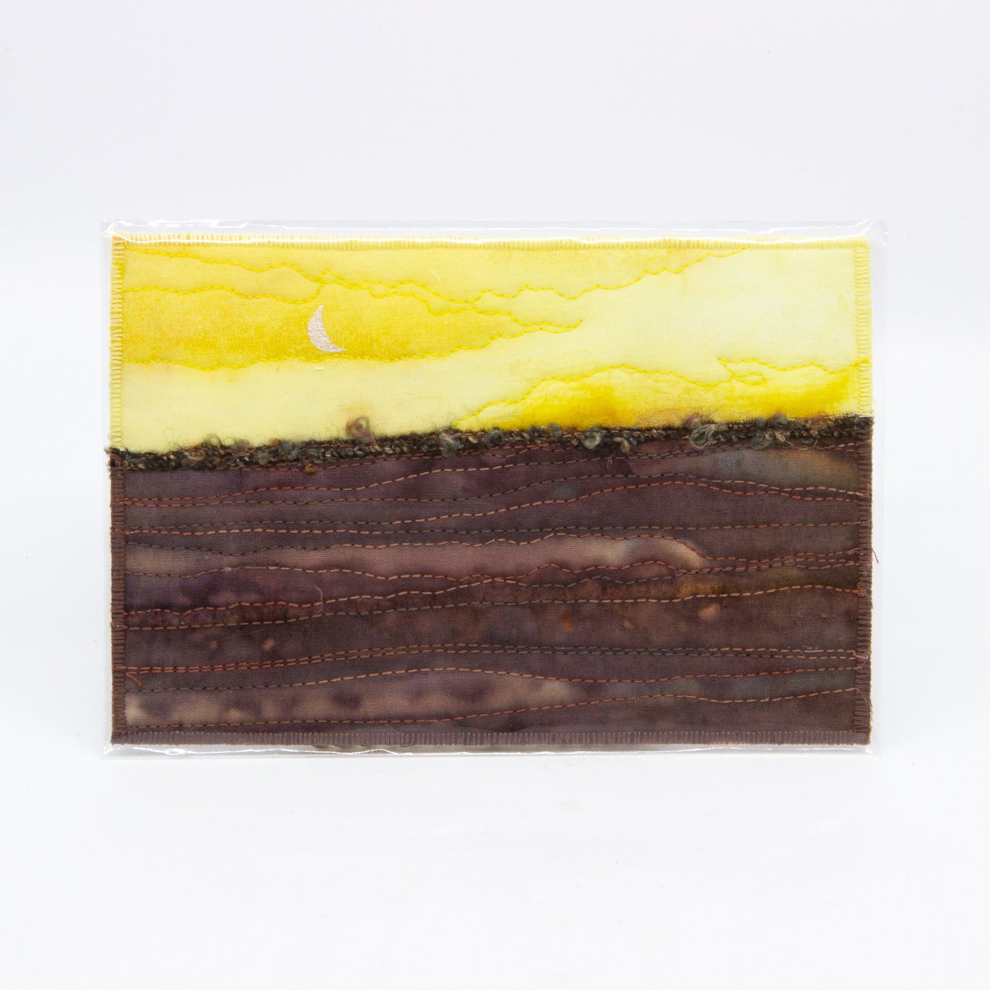 Yellow sky with moon, brown fields