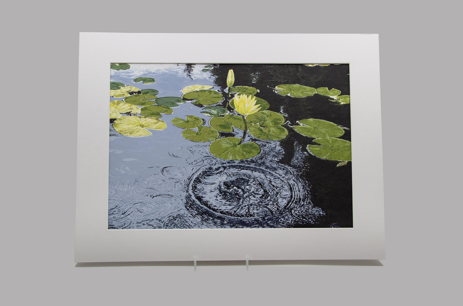 Silkscreen print of lily pads and waterlily in a rippling pond