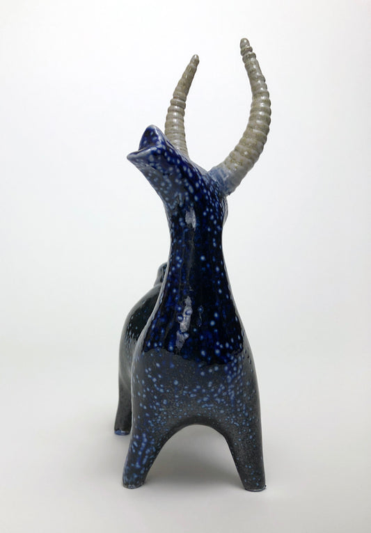 Clay statue of a blue stag speckled with white