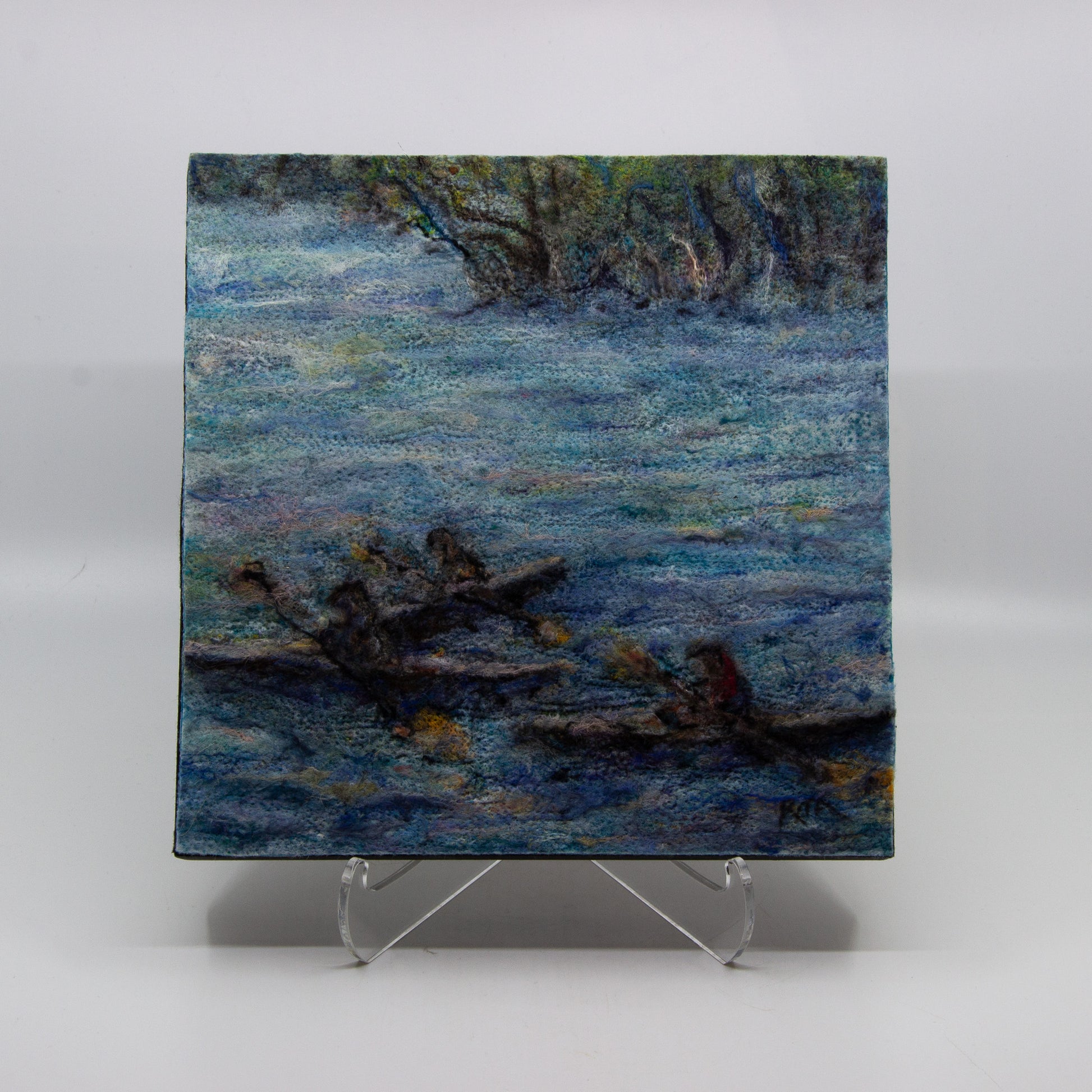 Felted painting of three kayakers in a river