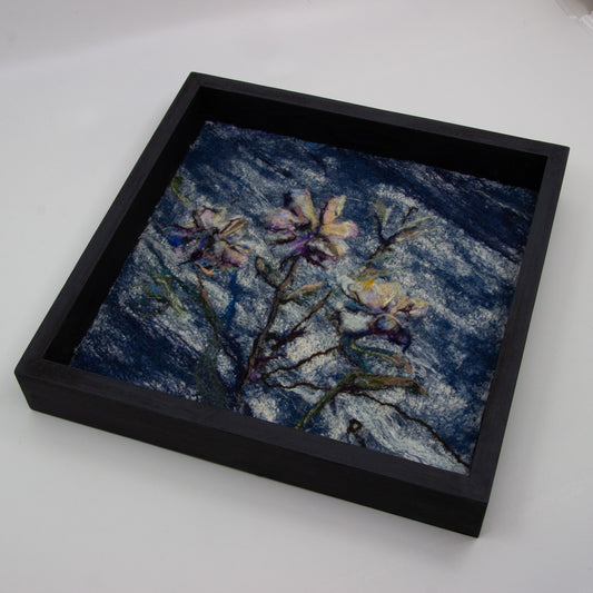 Felted flowers on blue background