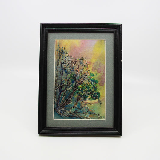 Thread painting of branches in front of the sun