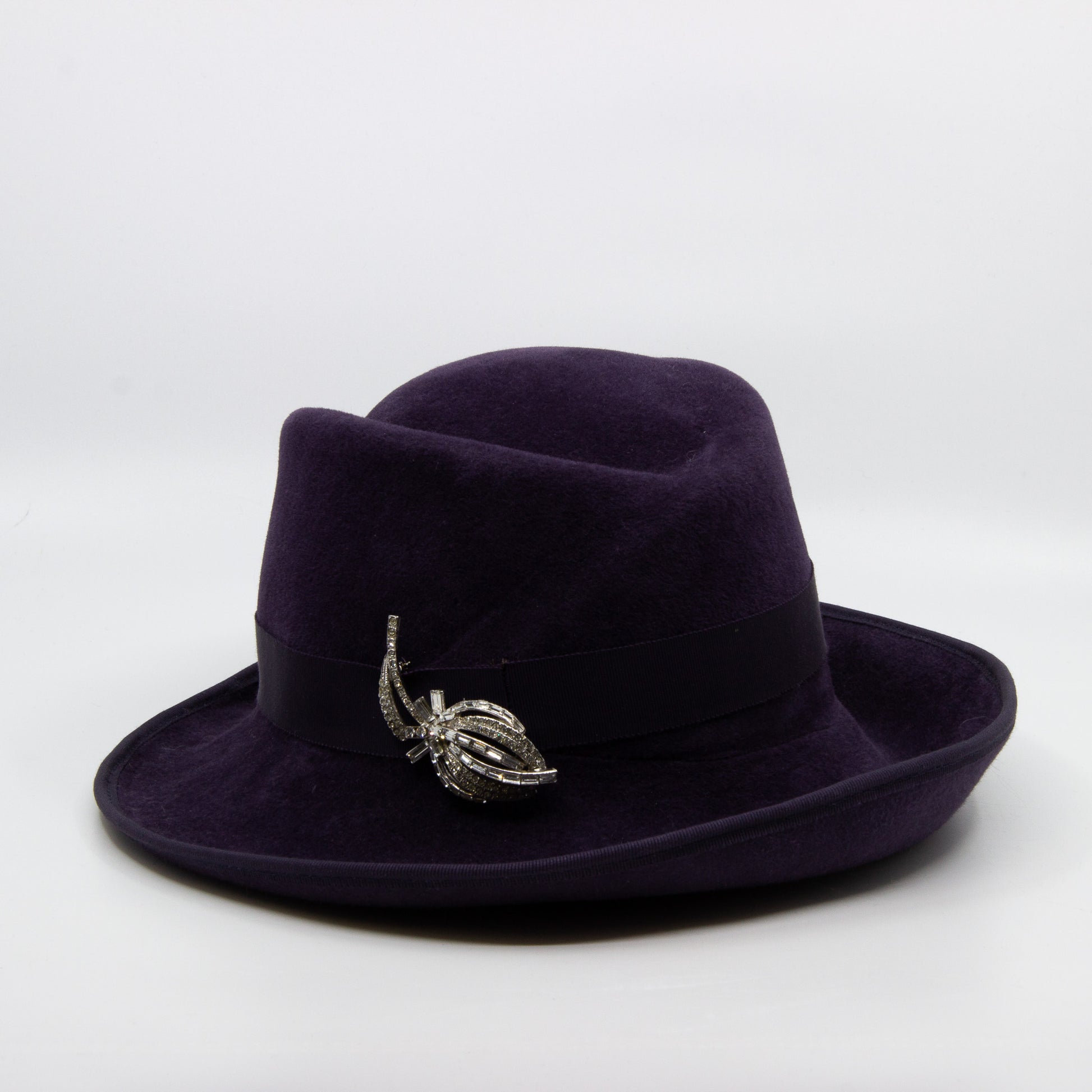 Purple fedora hat with silver pin
