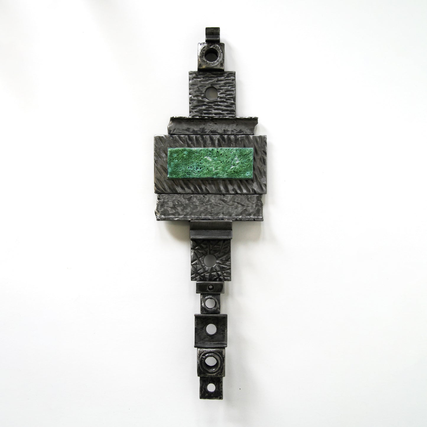 Metal wall hanging with green accent