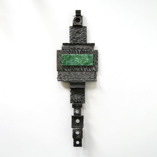 Metal wall hanging with green accent