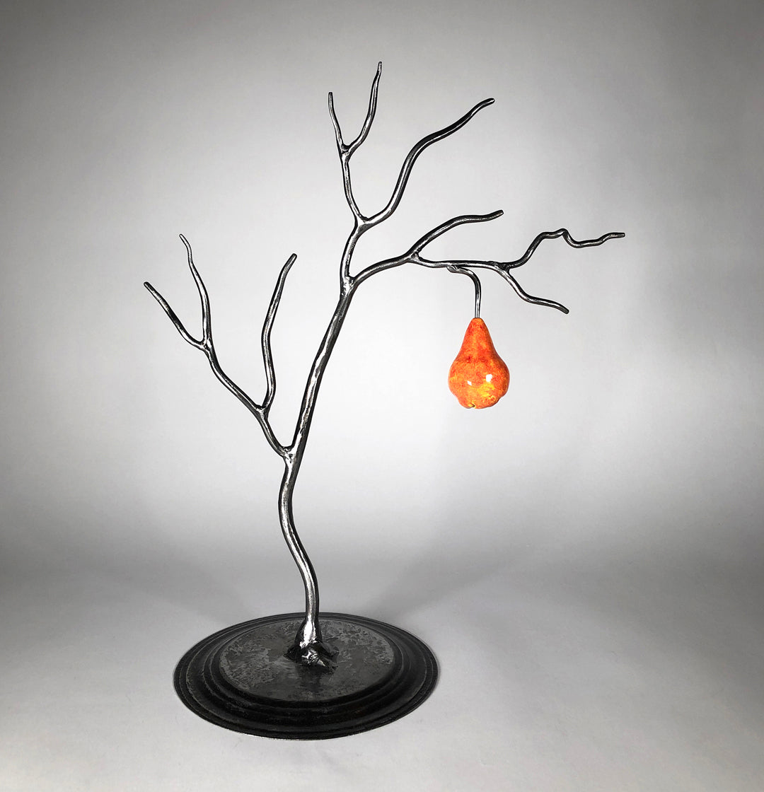 Small metal tree with one orange pear
