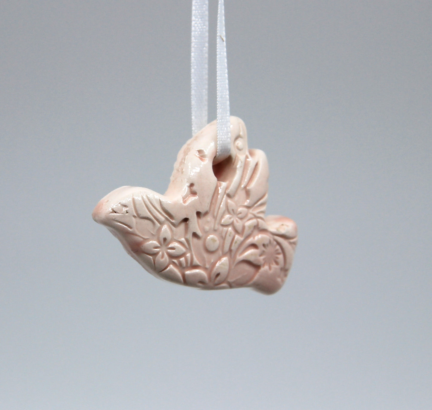 Light pink flower embossed with floral pattern