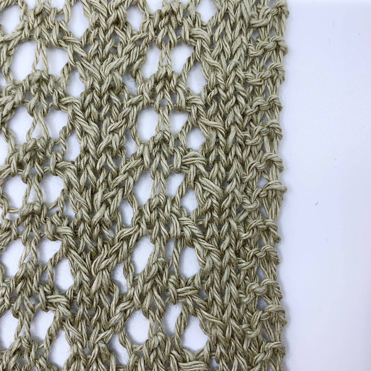 Close-up of a textured fabric pattern on a white background