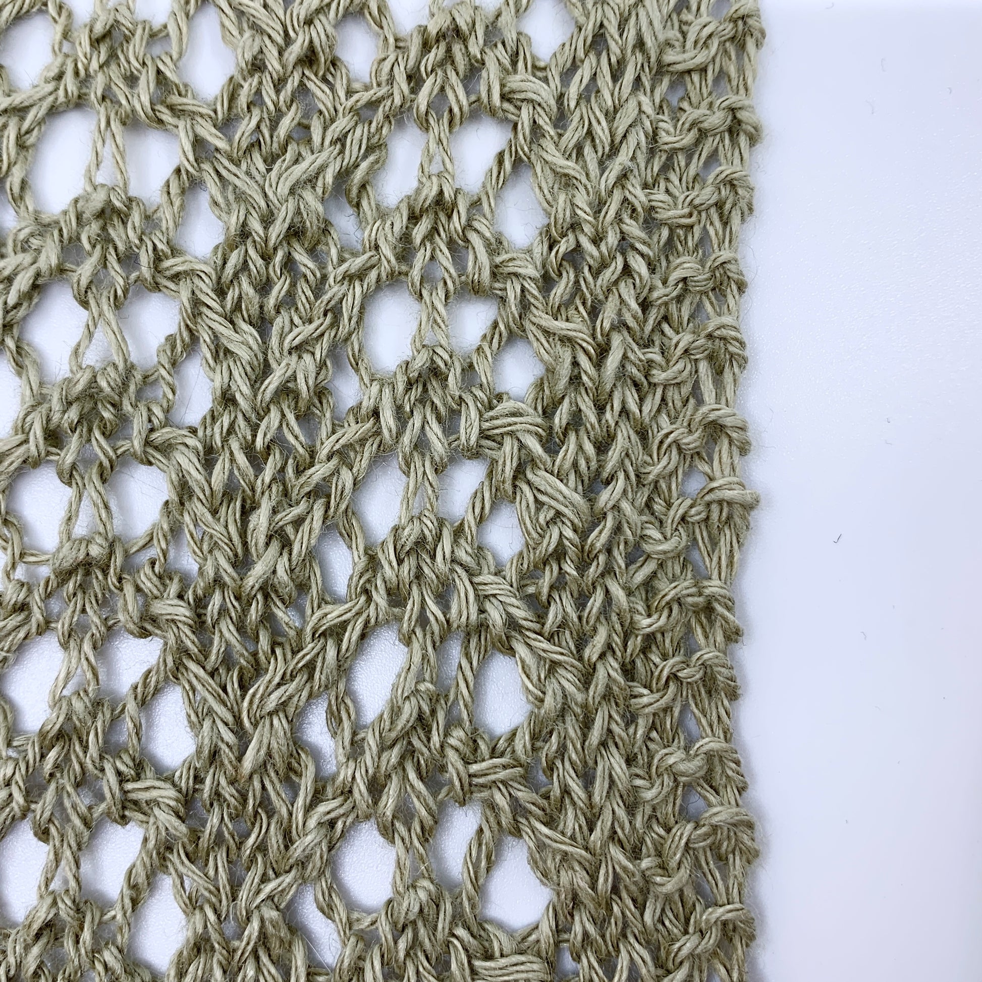 Close-up of a textured fabric pattern on a white background