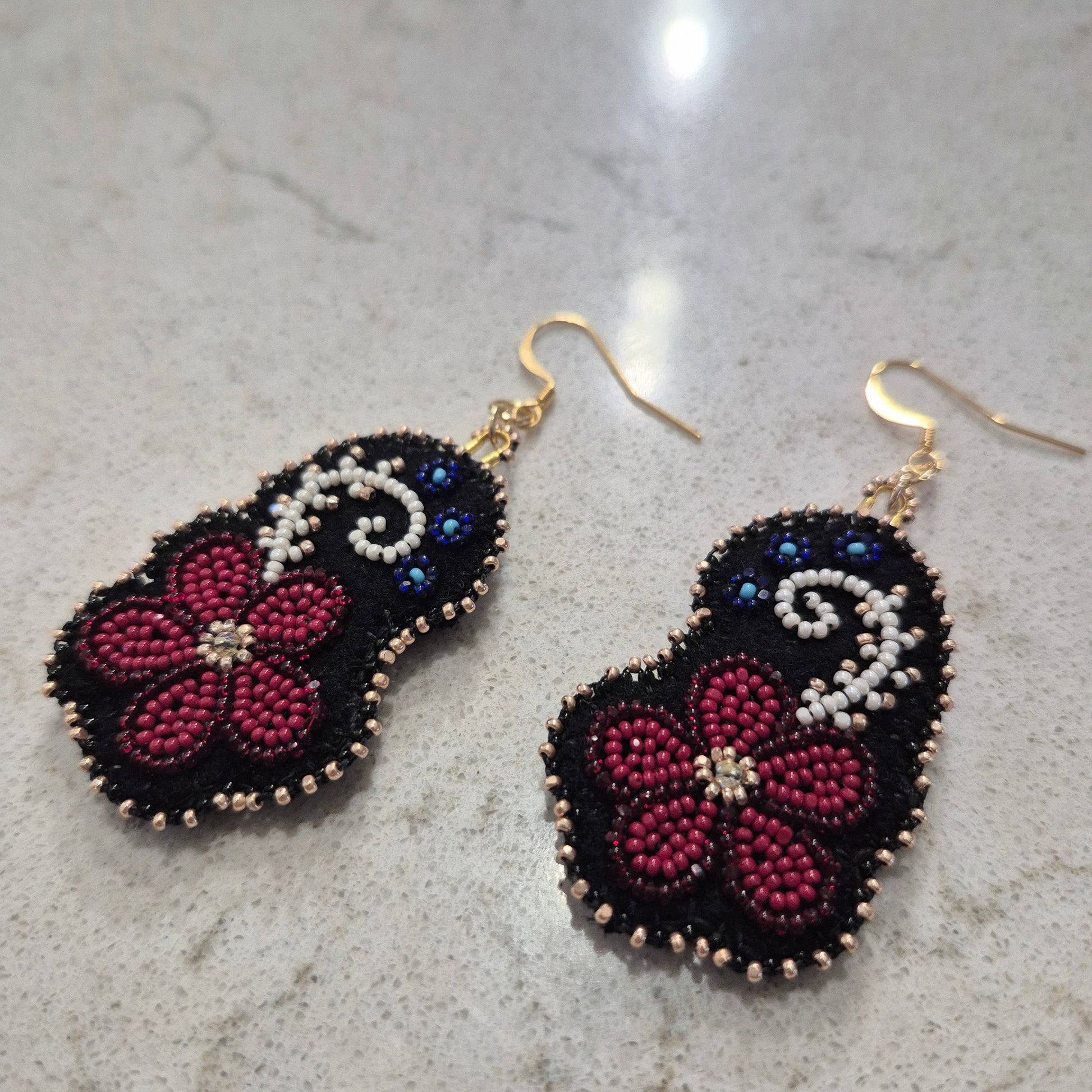 Beaded earings on black deer hide with gold hardware