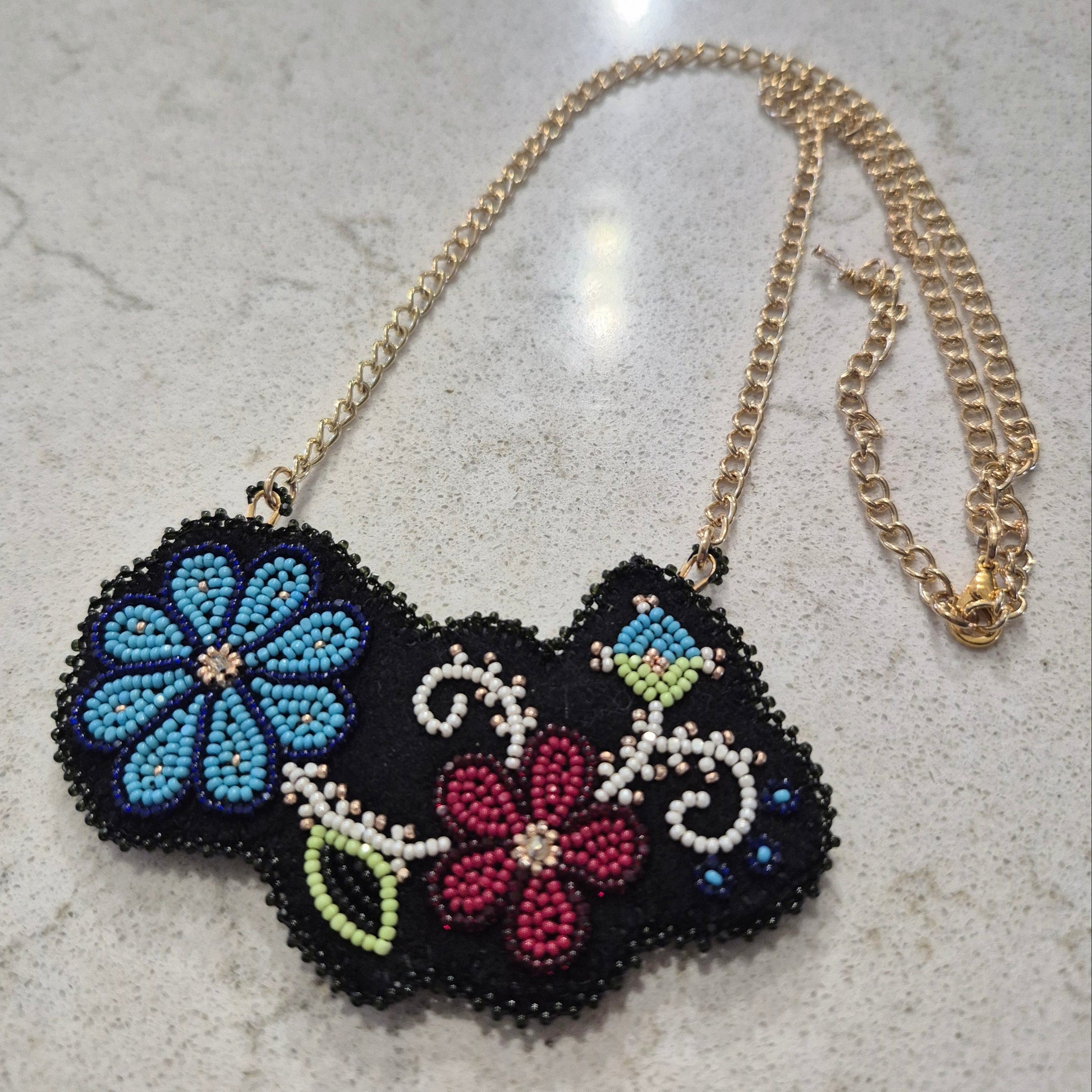 Beaded necklace with black felt and gold chain