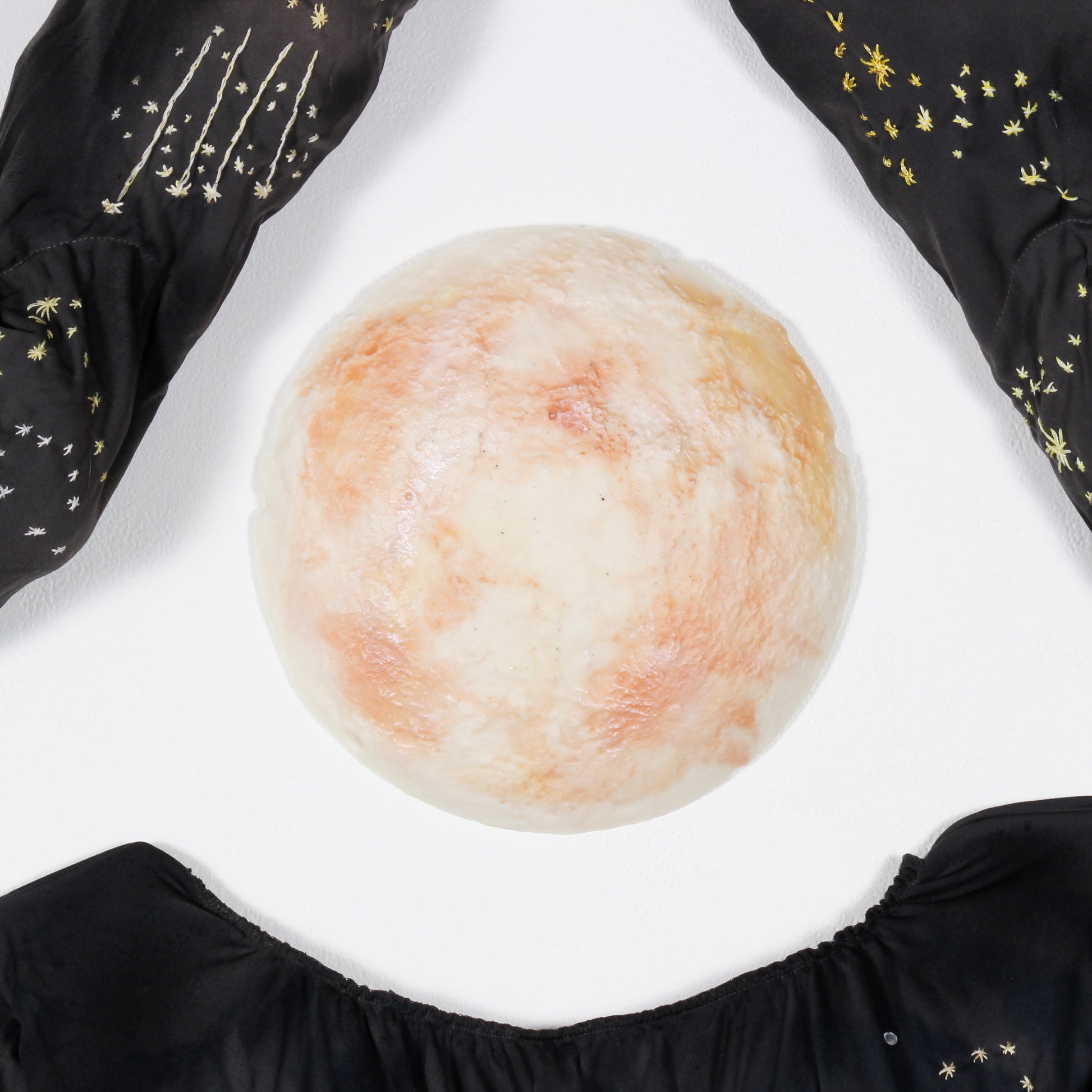 A close up photo of a wax full moon head.