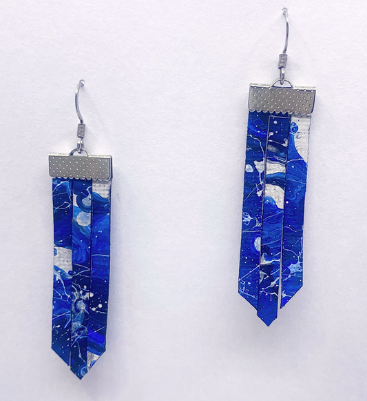 Blue marbled earrings with silver accents on a white background