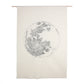 A large white wall hanging, featuring a grey embroidered image of the full moon.