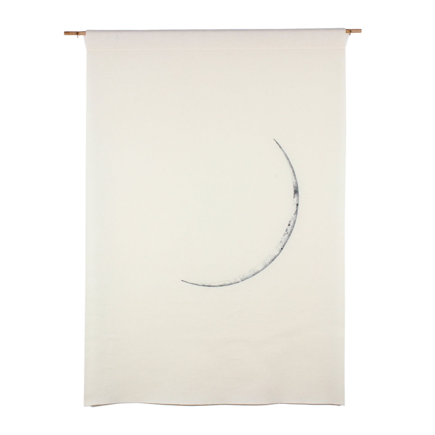 A large white wall hanging, featuring a grey embroidered image of a thin crescent moon.