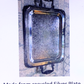 A square metal tray with rounded corners and two dark handles, shown on a light background with text below reading 'Made from recycled Silver Plate shown in picture'.