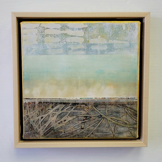 Framed abstract artwork with a gradient background and textured elements.