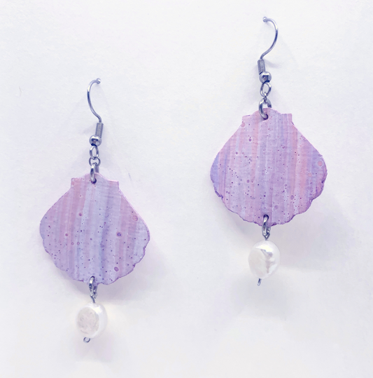 Pair of pink and purple marbled shell-shaped earrings with pearl accents on a white background