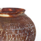 Close up shot of a round ceramic vessel. The mouth is smooth and symmetrical, with rust brown crackly texture.