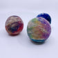 Three multicolored felted balls on a white background