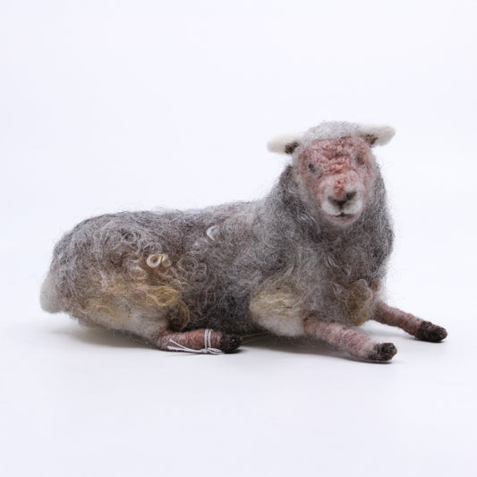 sheep laying down; felted 