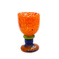 Glass goblet with orange cup, blue stem, and green accent 