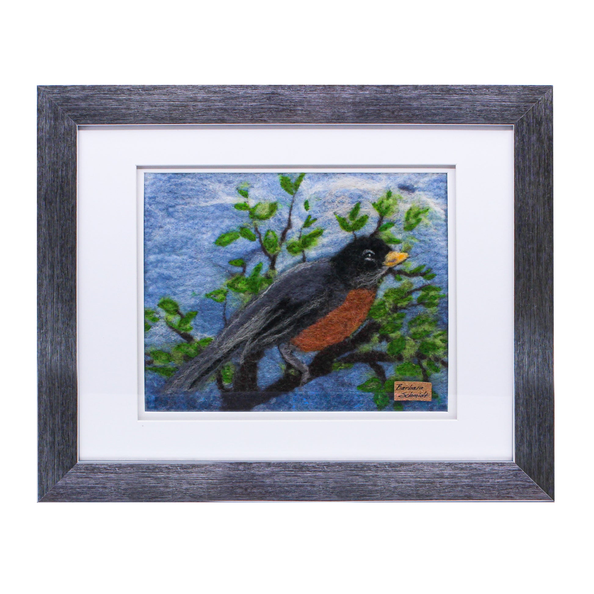 Felted picture of a robin on blue sky 