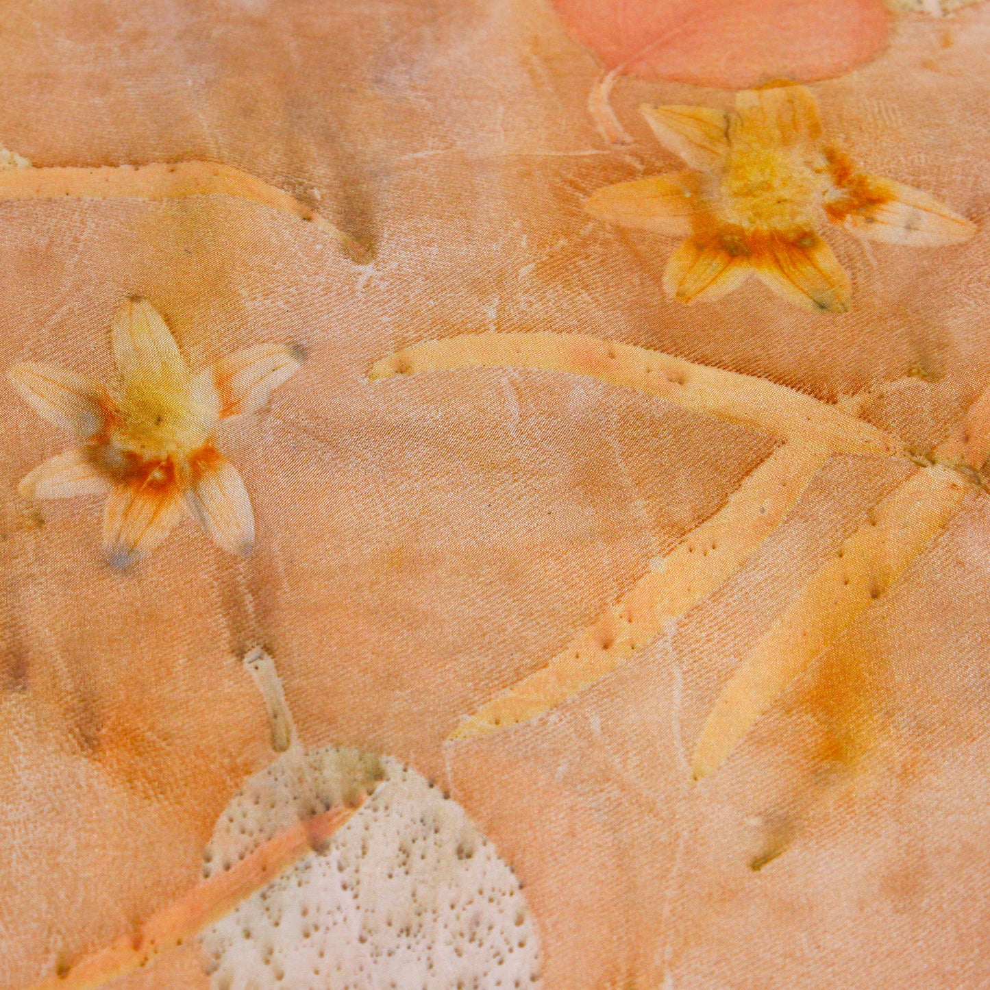 Orange silk scarf close up of flowers and leaves