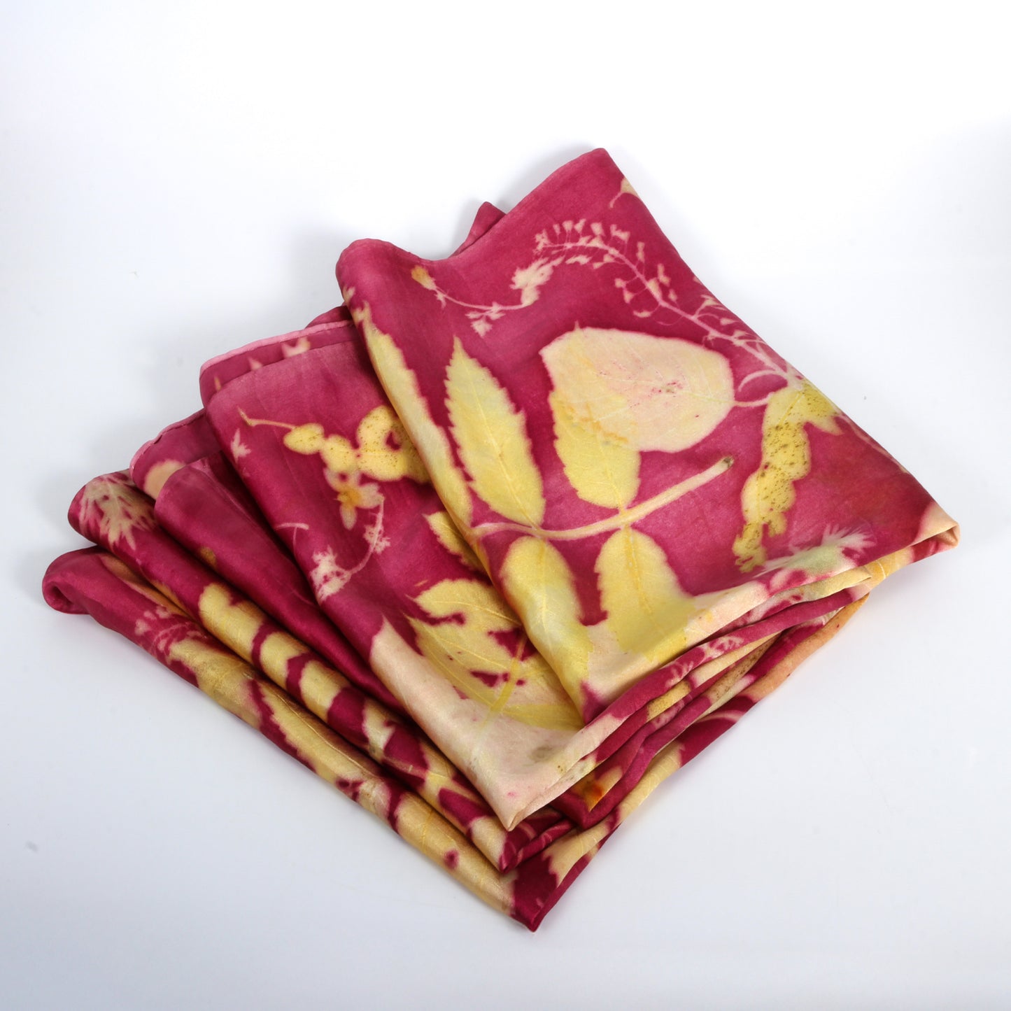 Stack of red and yellow patterned fabric pieces on a white background
