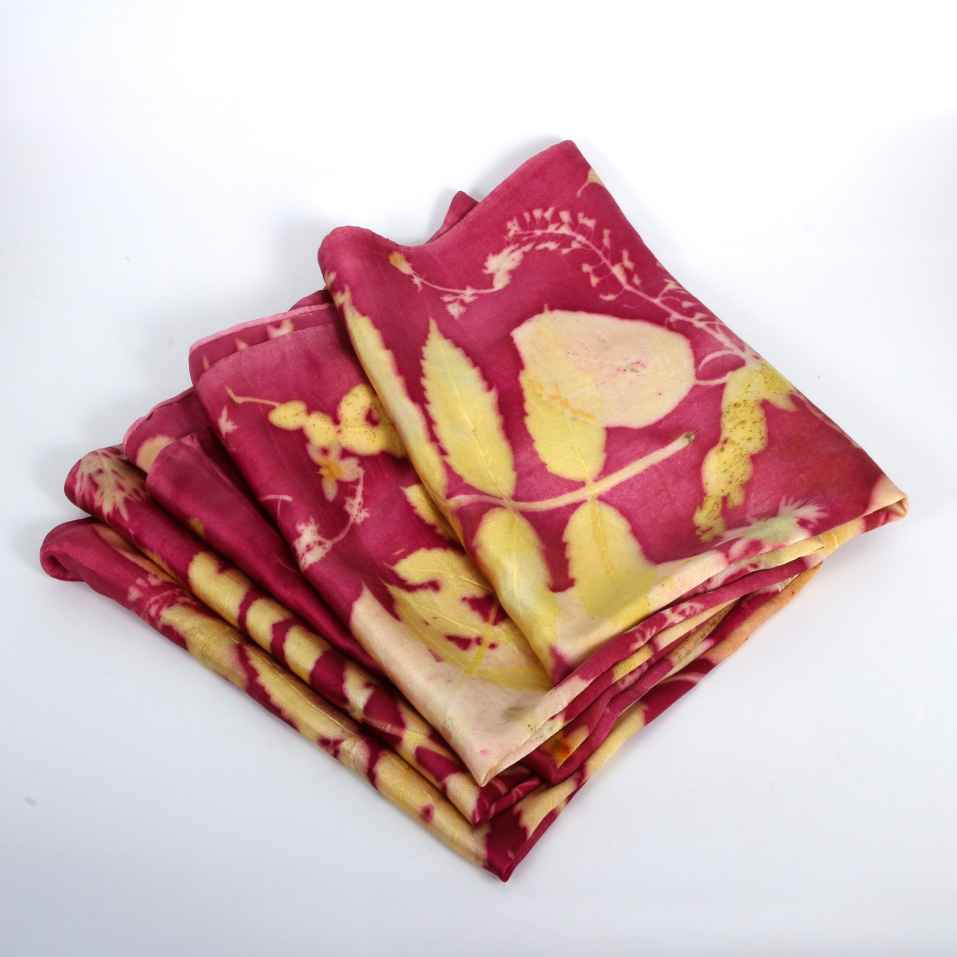 Stack of red and yellow patterned fabric pieces on a white background